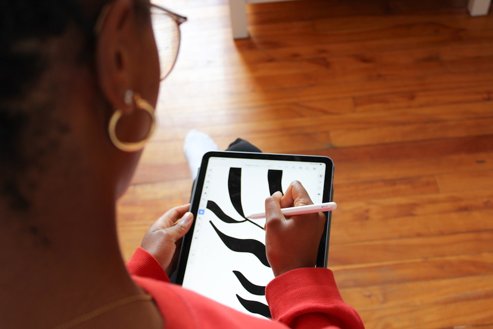 a woman holding a tablet with a zebra pattern on it