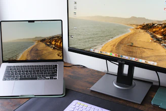 a laptop computer sitting on top of a wooden desk