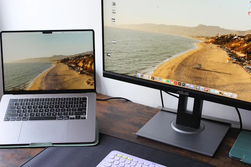 a laptop computer sitting on top of a wooden desk