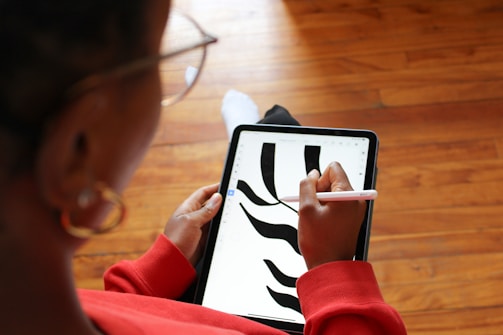 a woman is using a tablet with a zebra pattern on it