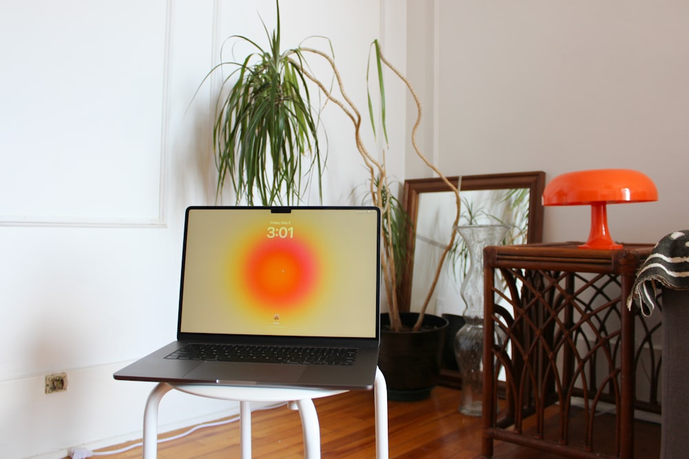 a laptop computer sitting on top of a wooden table