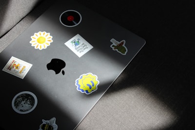 a laptop with a bunch of stickers on it