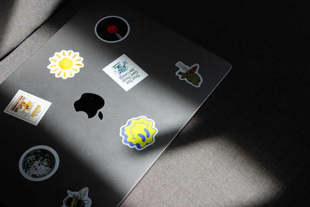 a laptop with a bunch of stickers on it