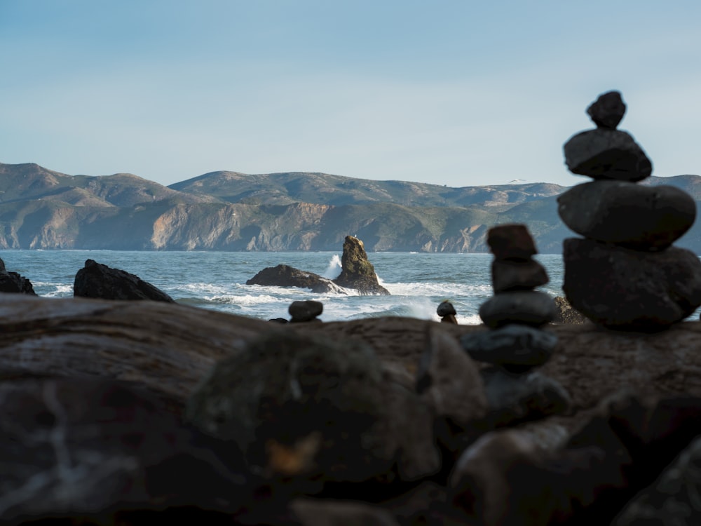rocks stacked on top of each other near the ocean