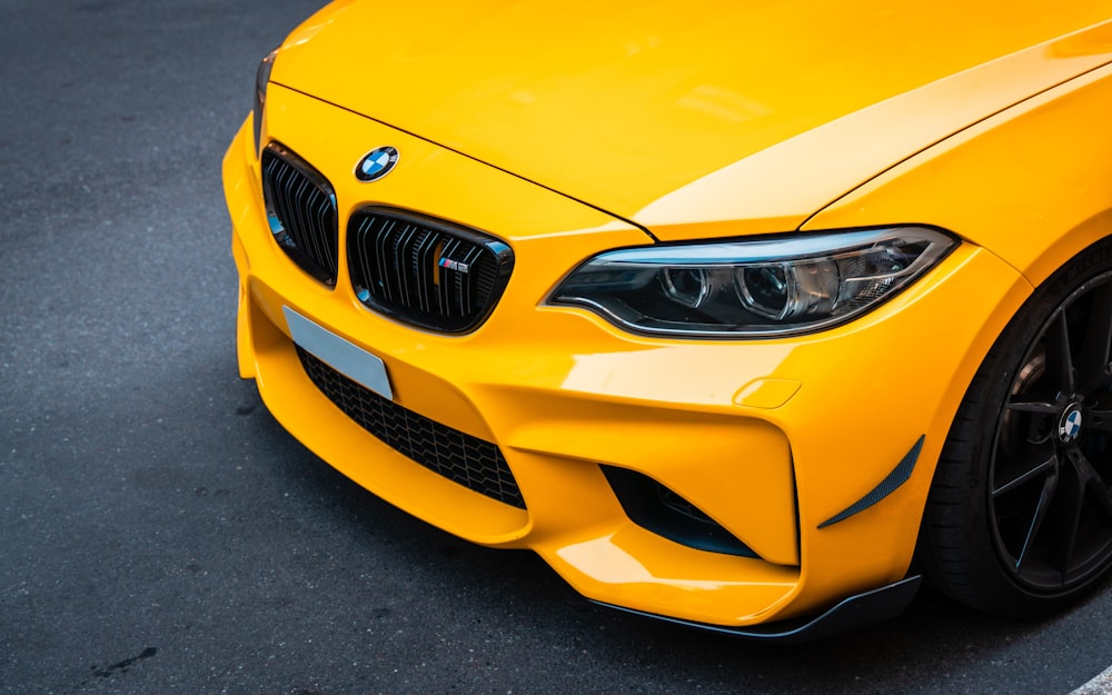 a close up of the front of a yellow car