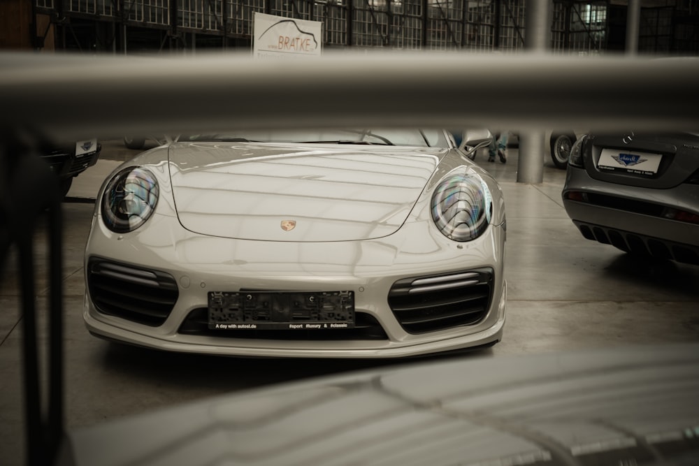 a white sports car parked in a garage