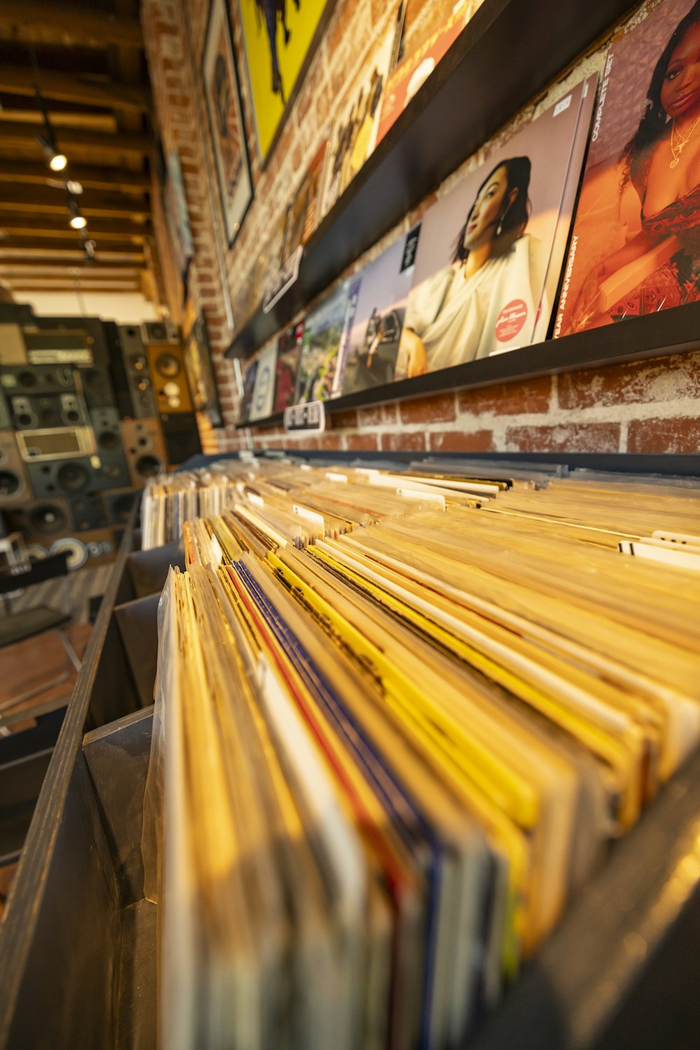 a stack of records sitting on top of a wooden shelf