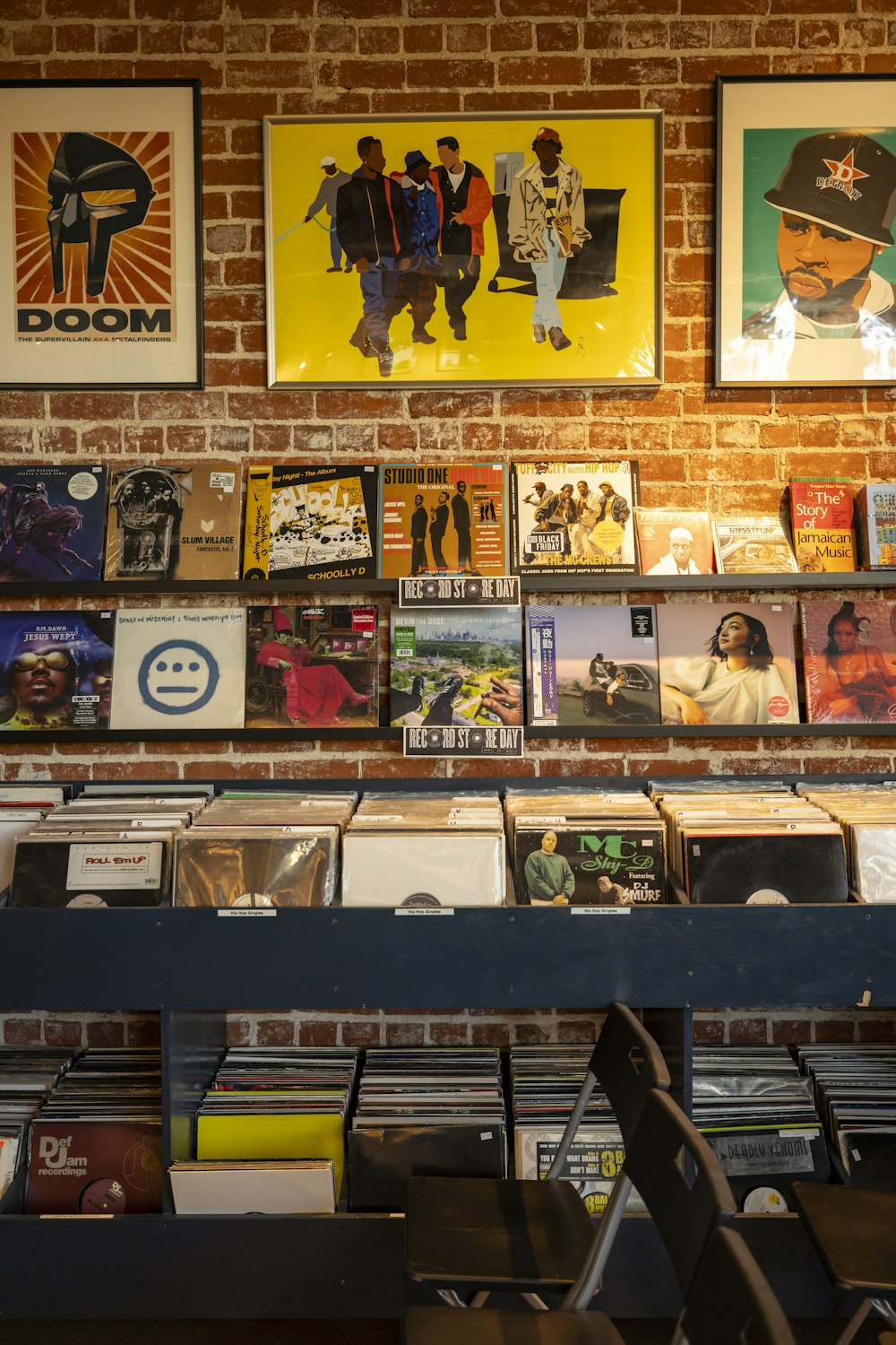 a brick wall with various records on it