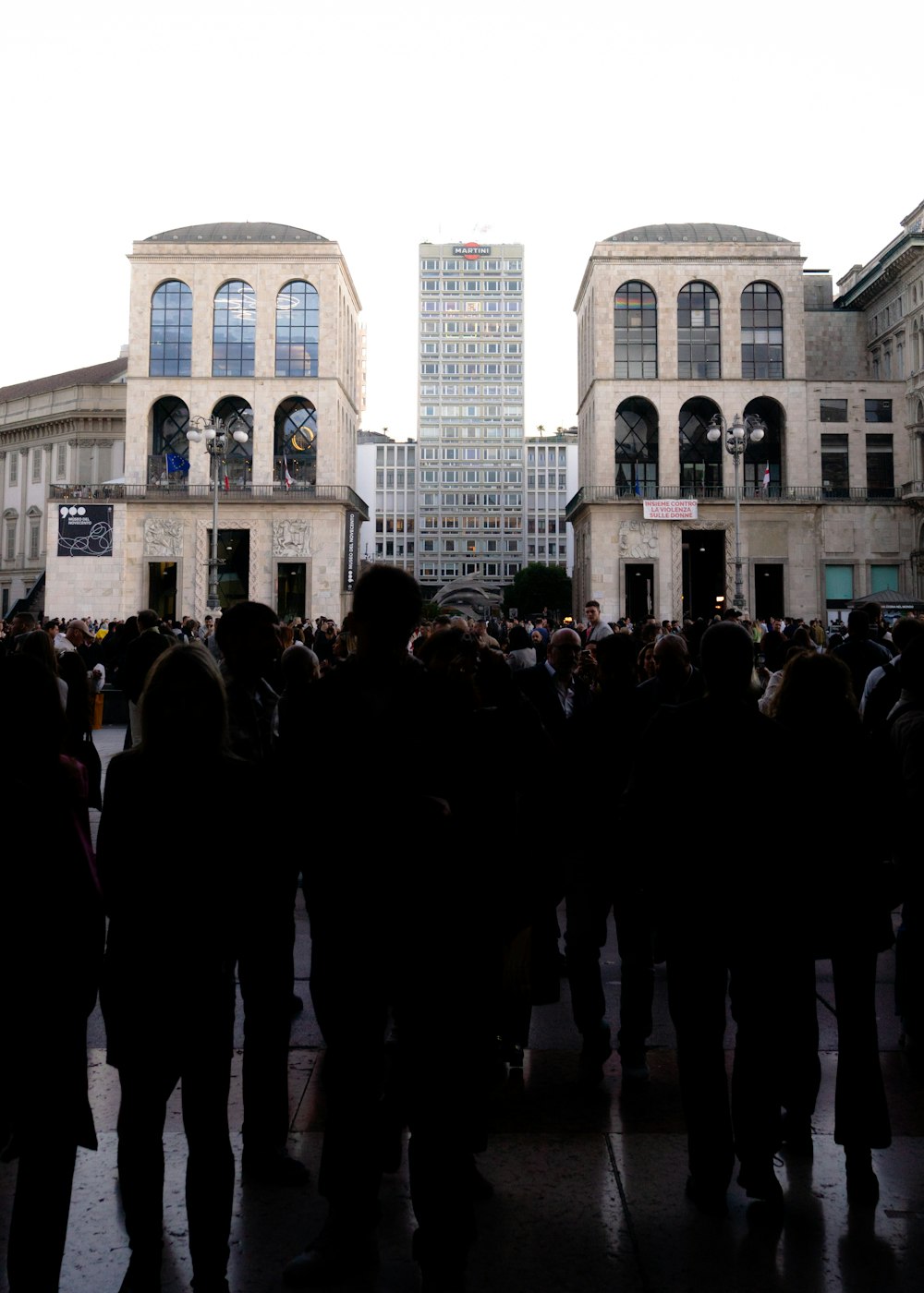 a crowd of people standing in front of a building