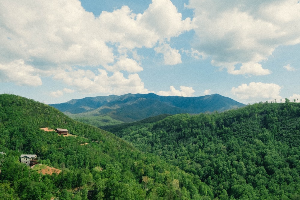 a scenic view of a green mountain range