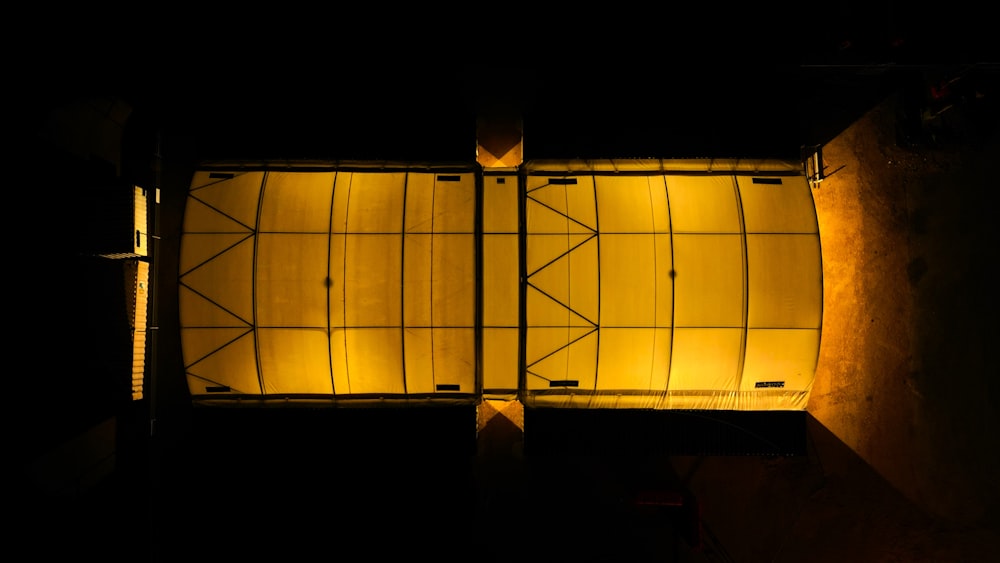 an overhead view of a building lit up at night