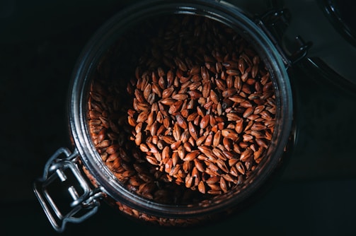 a glass jar filled with lots of seeds