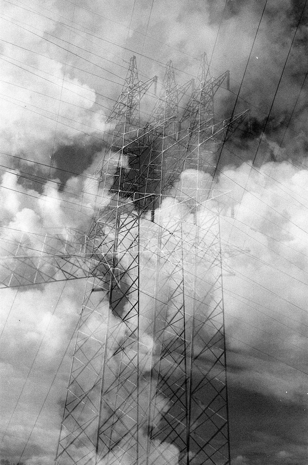 a black and white photo of power lines and clouds