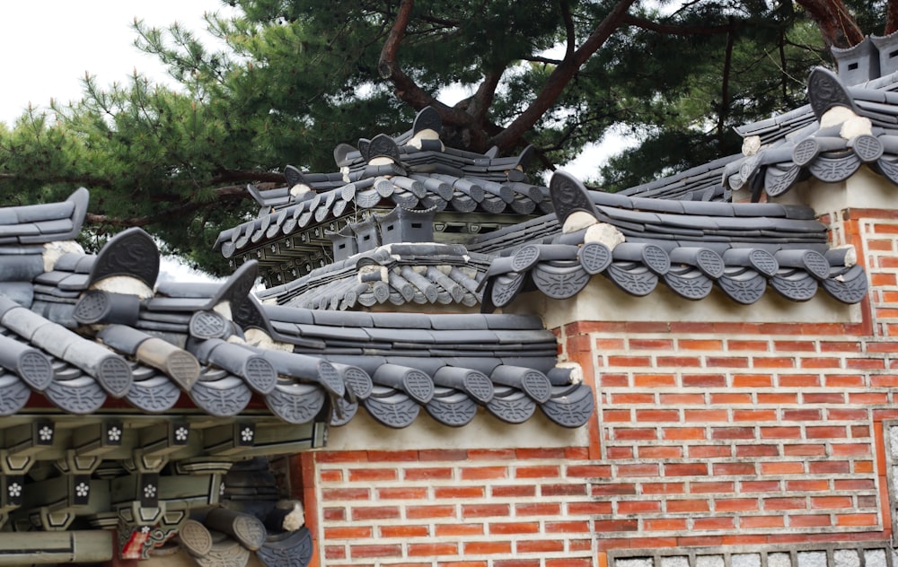 a close up of a roof with a tree in the background