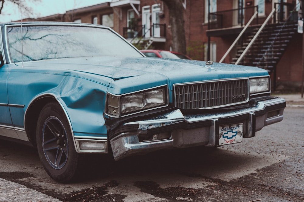 a blue car parked on the side of the road