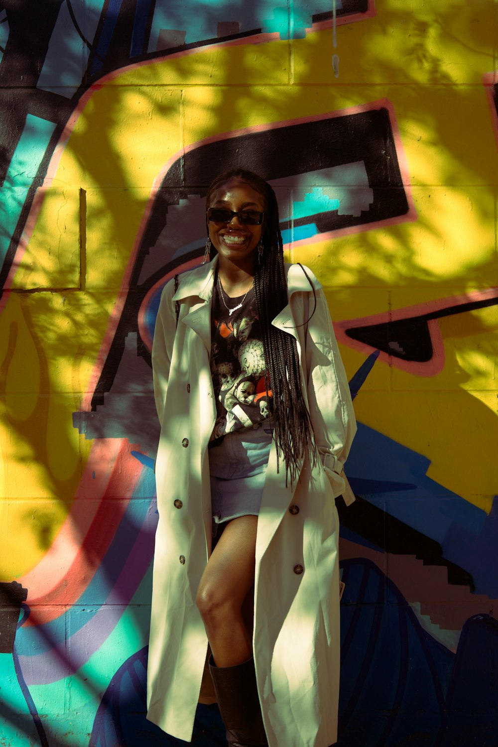 a woman standing in front of a colorful wall