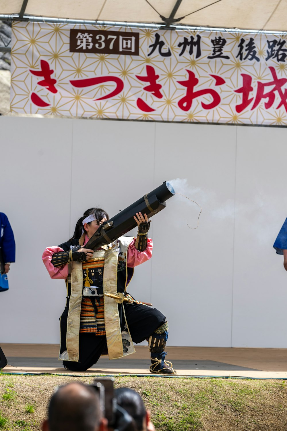 a man in a costume holding a large pipe