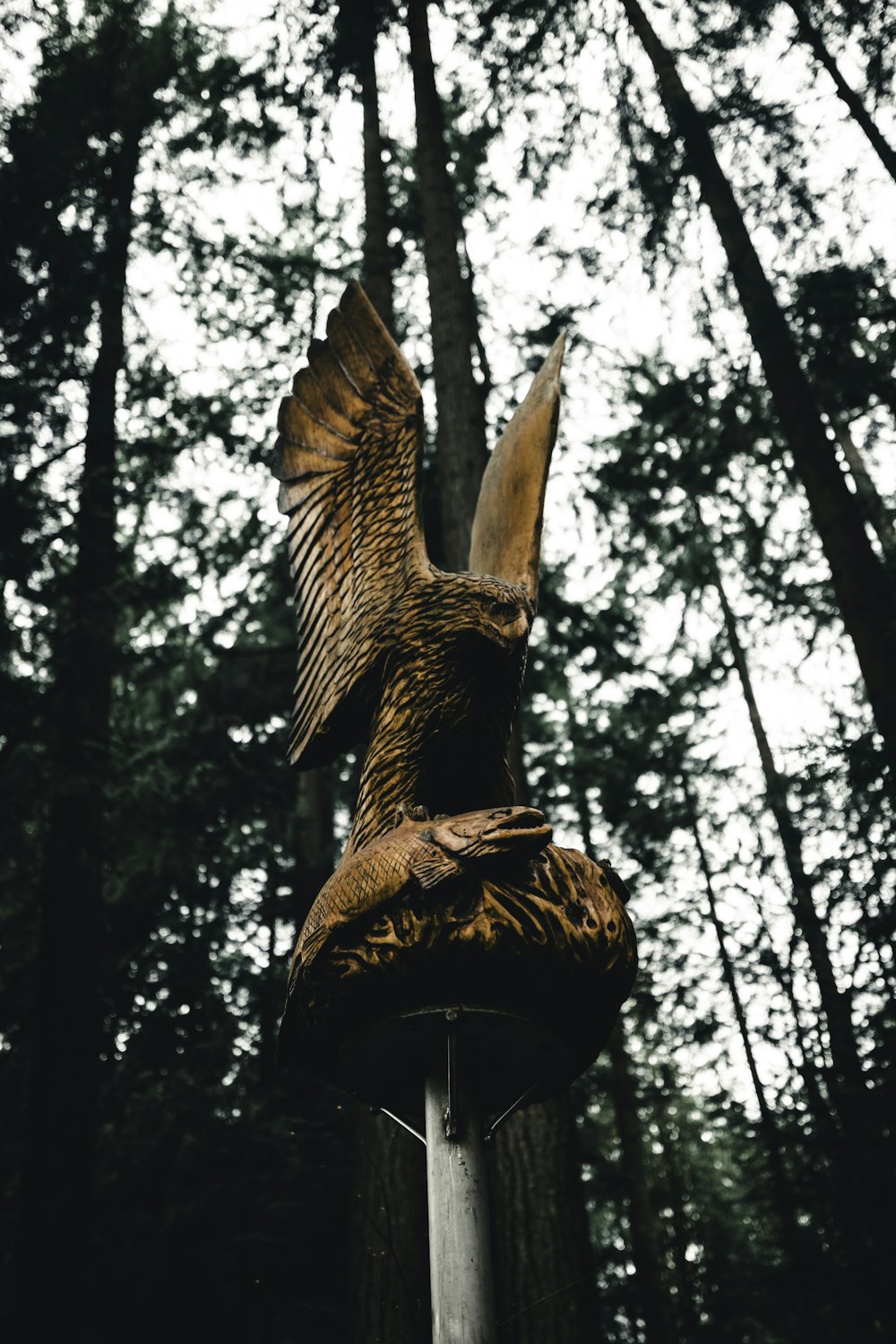 uma estátua de uma águia em cima de um poste