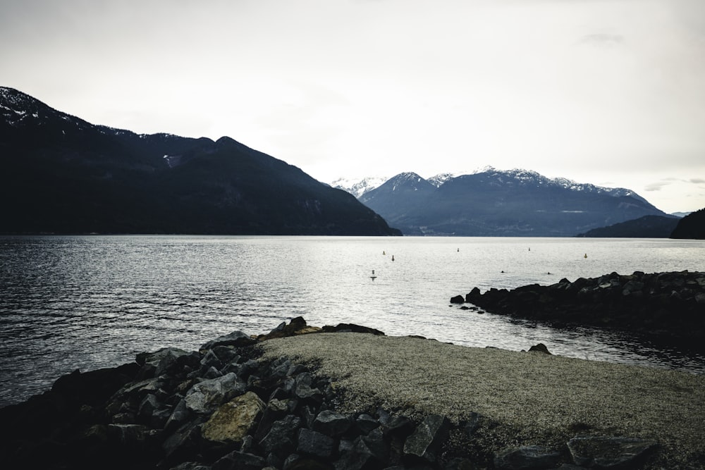 a body of water with mountains in the background