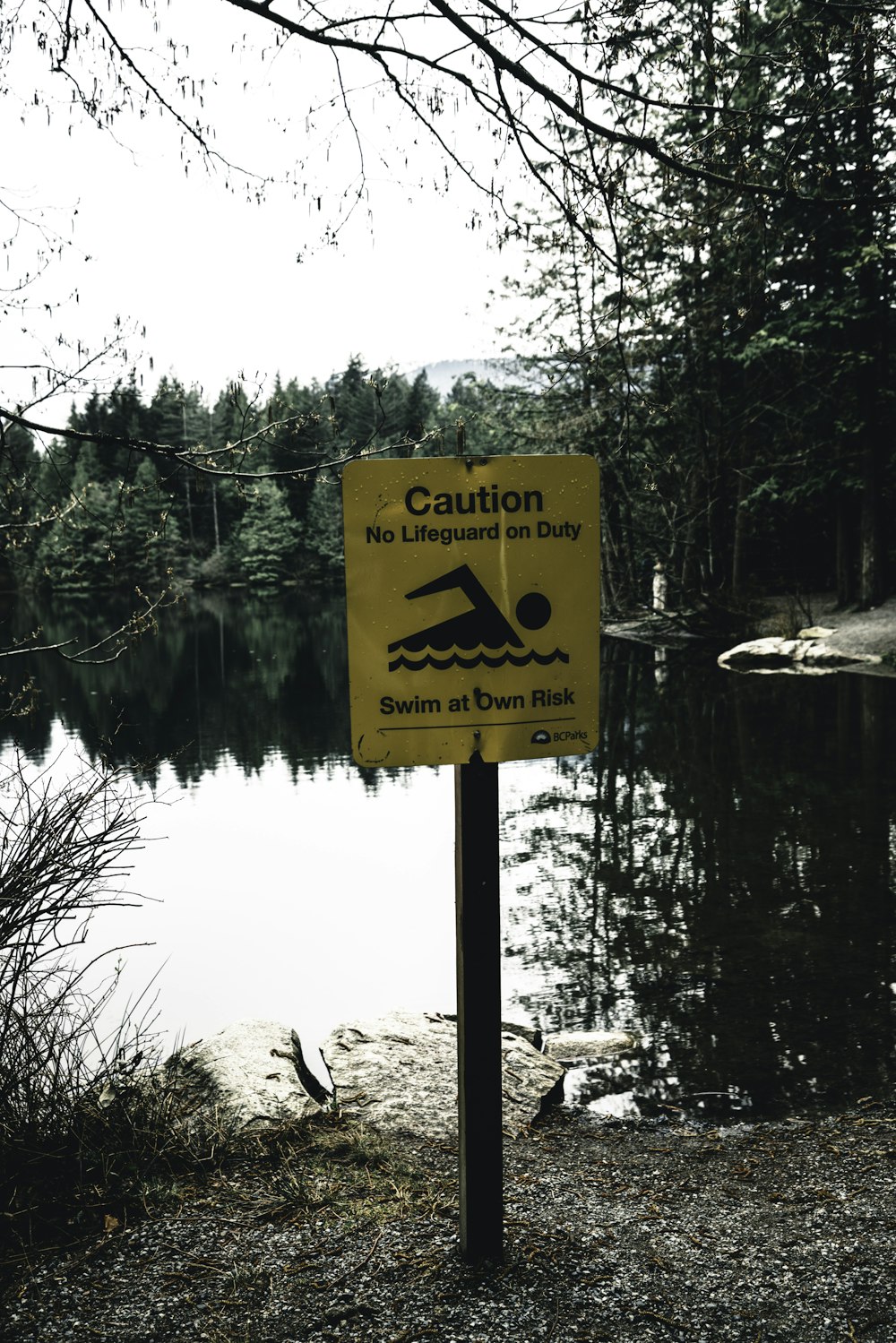 a caution sign is posted near a body of water