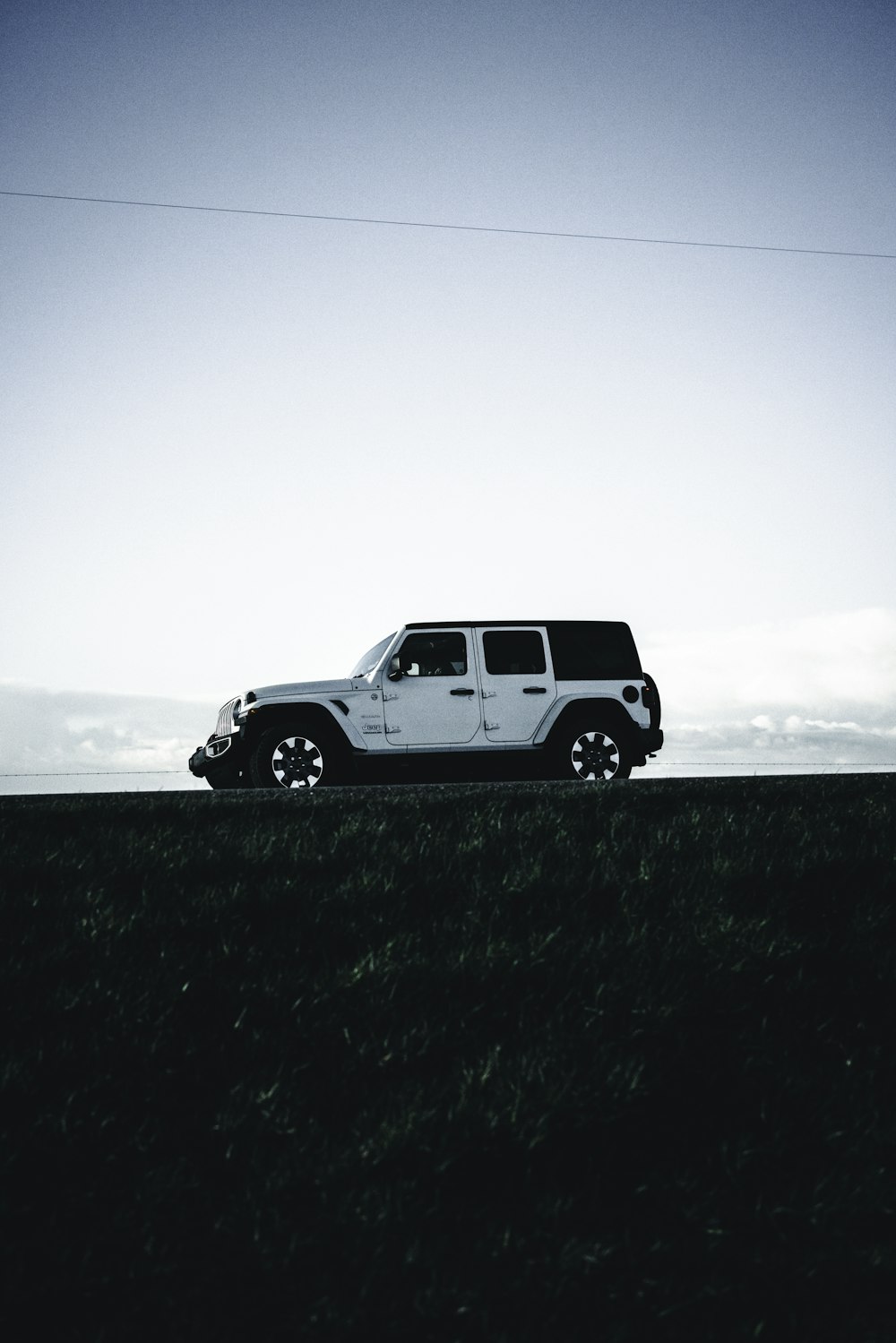 a jeep is parked on the side of a hill