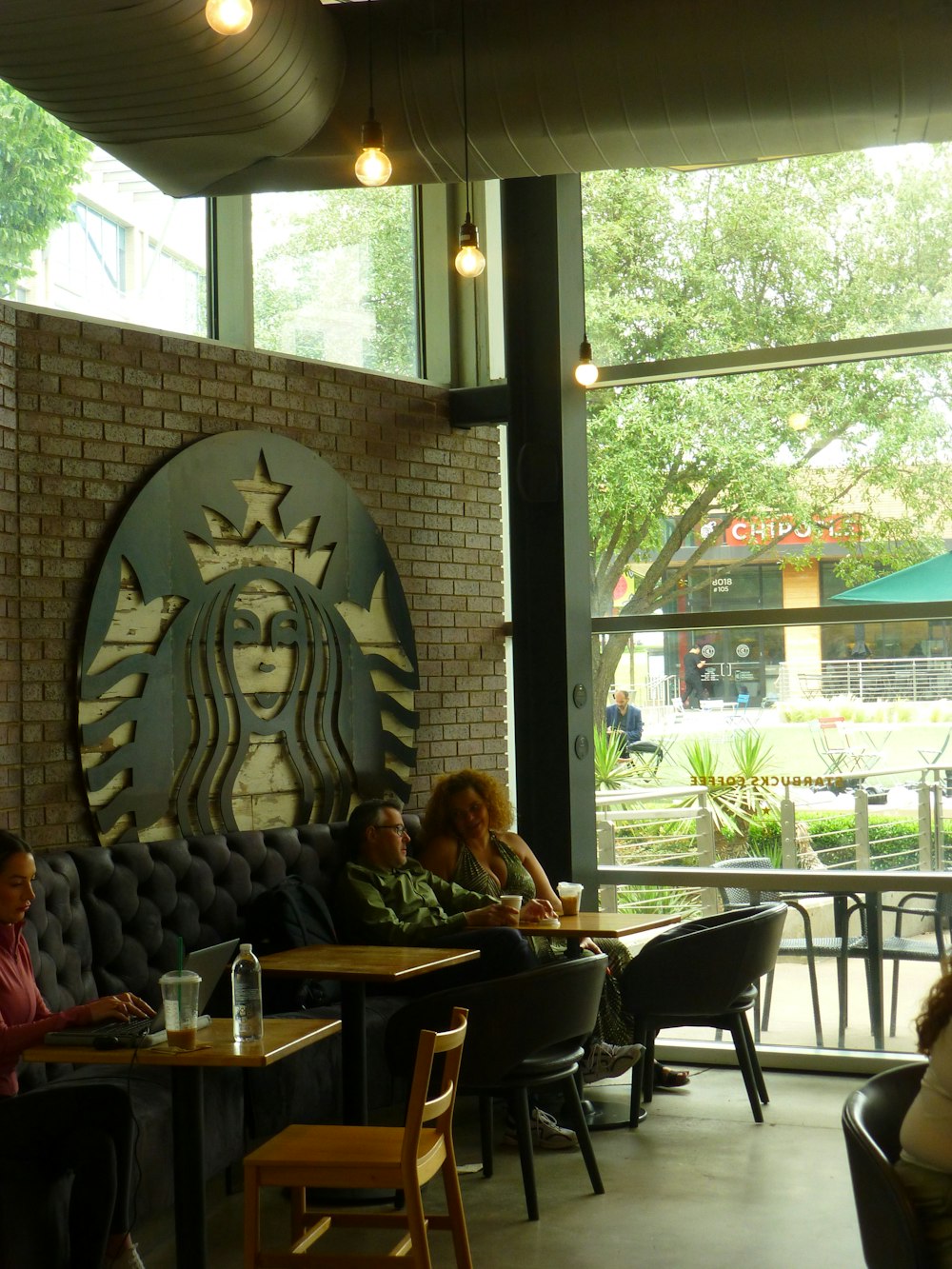 a group of people sitting at tables in a restaurant