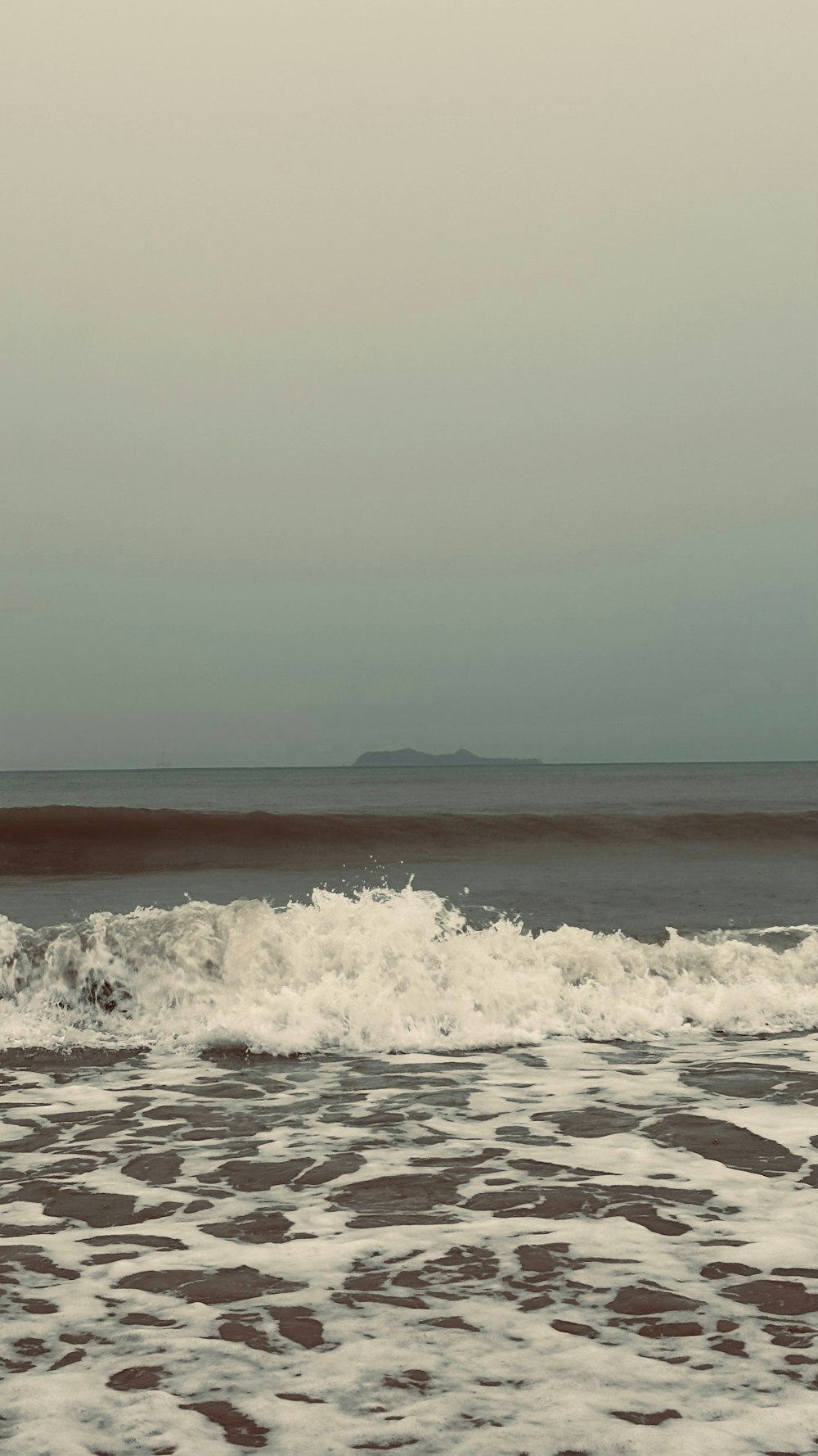 a man riding a surfboard on top of a wave in the ocean