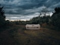 a couch sitting in the middle of a field