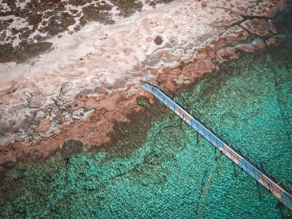 an aerial view of a bridge over a body of water