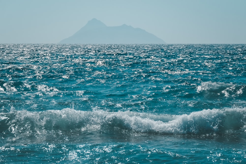 a large body of water with a small island in the distance