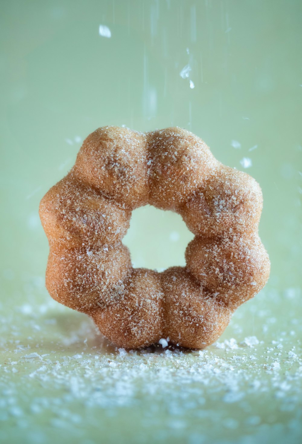 a sugary donut is sprinkled with sugar