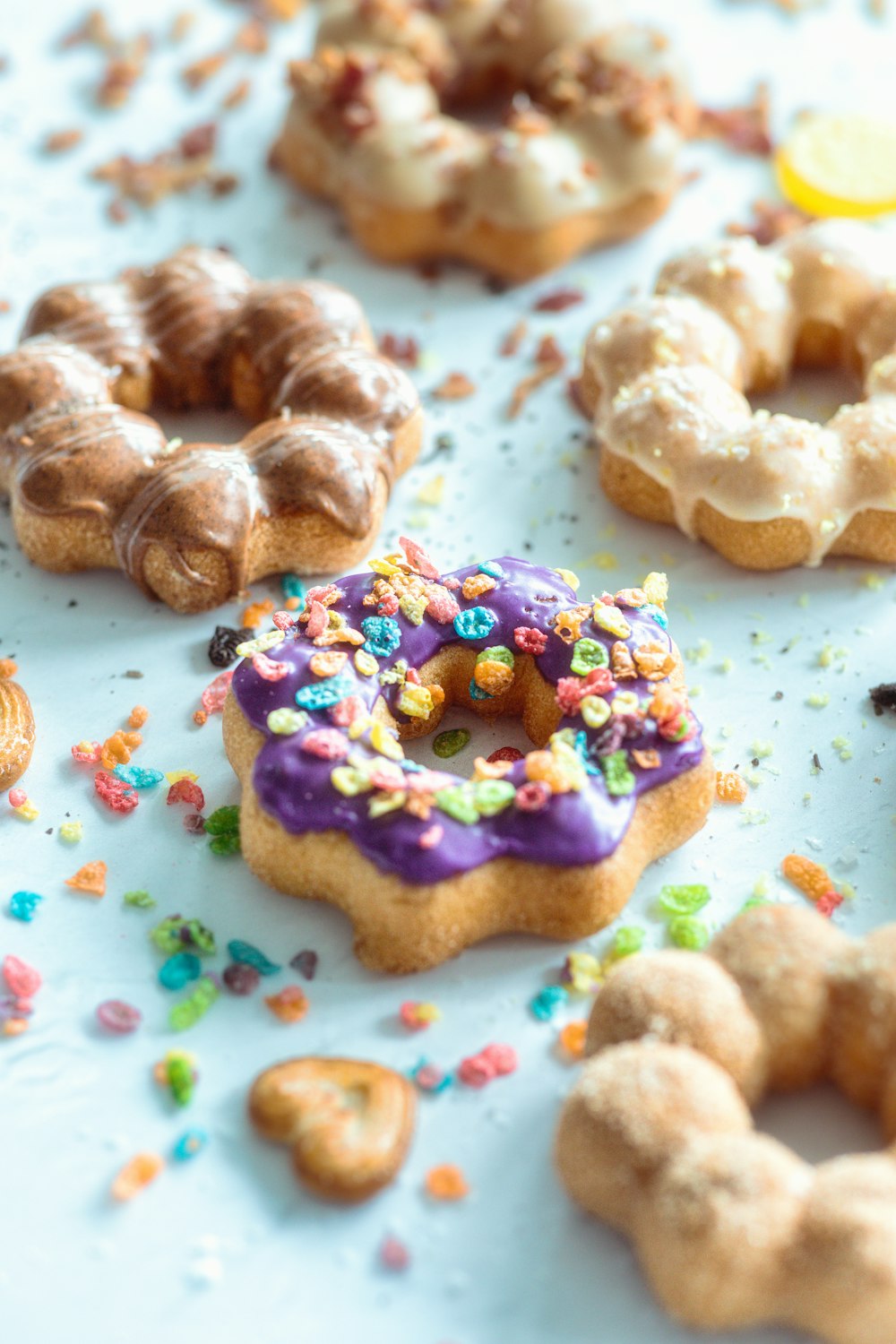 a table topped with lots of donuts covered in sprinkles