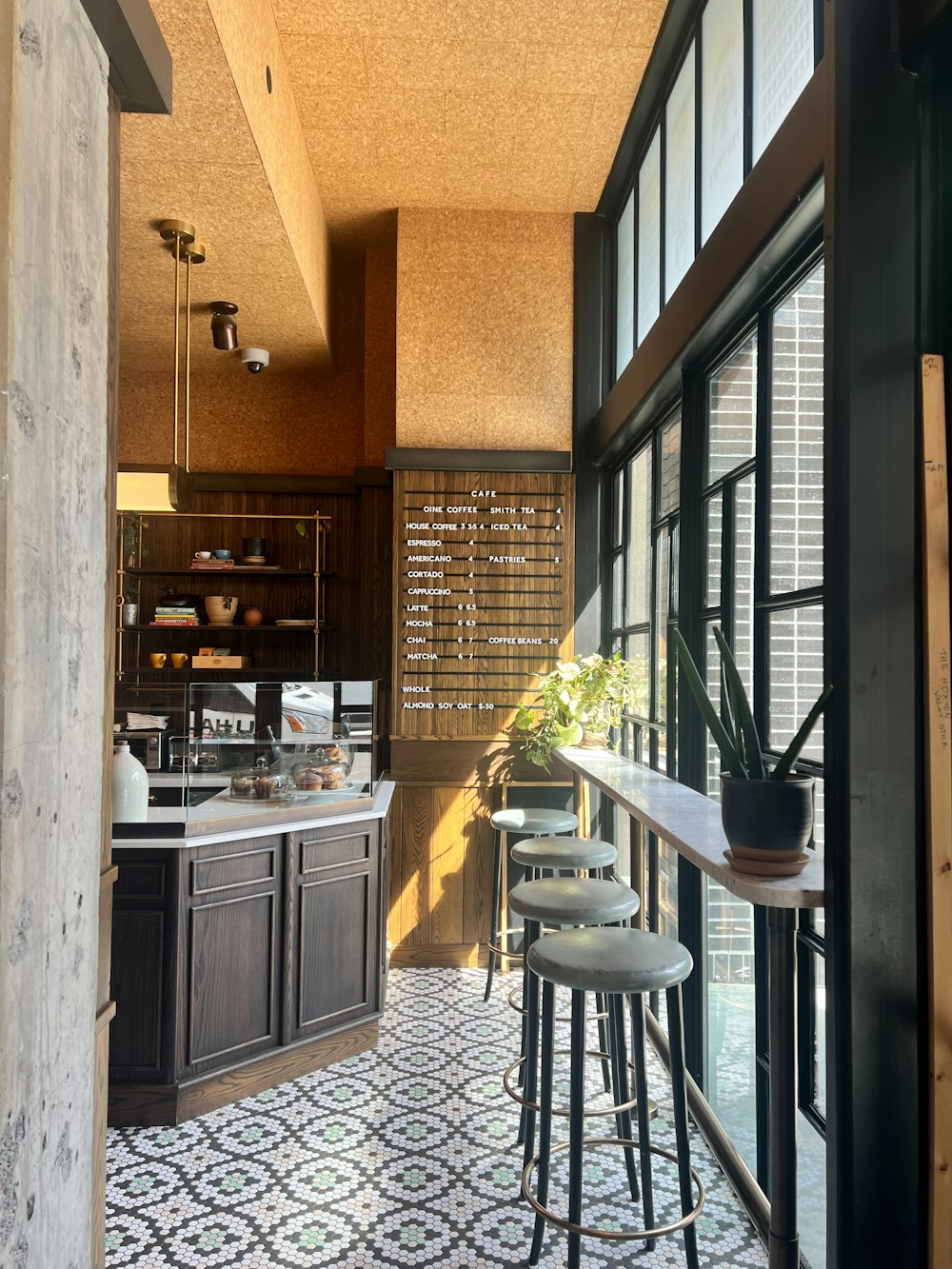 a kitchen with a tiled floor next to a window