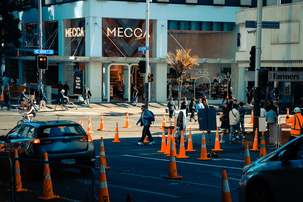 a city street with traffic cones and people walking