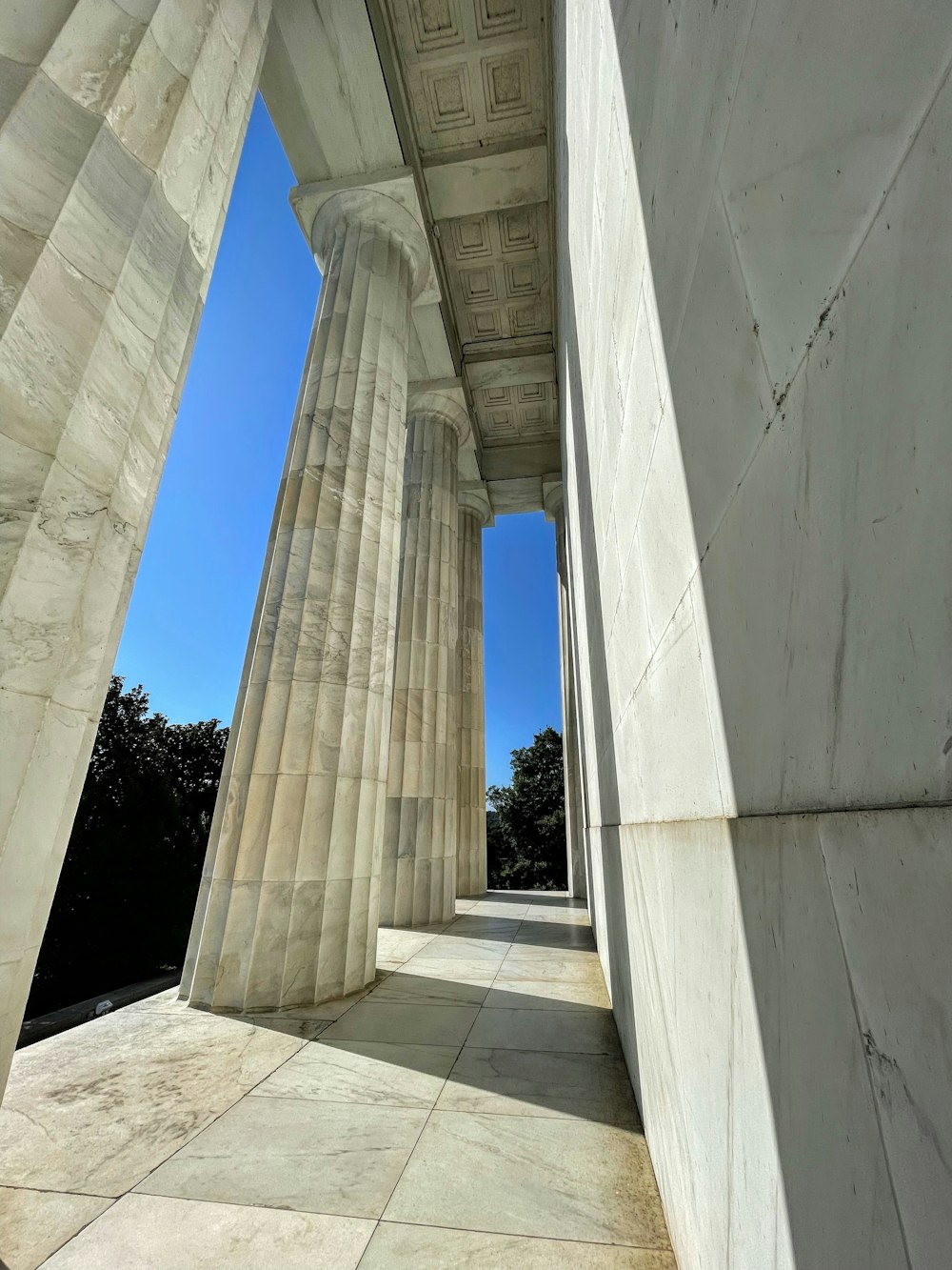 the columns of the lincoln memorial against a blue sky