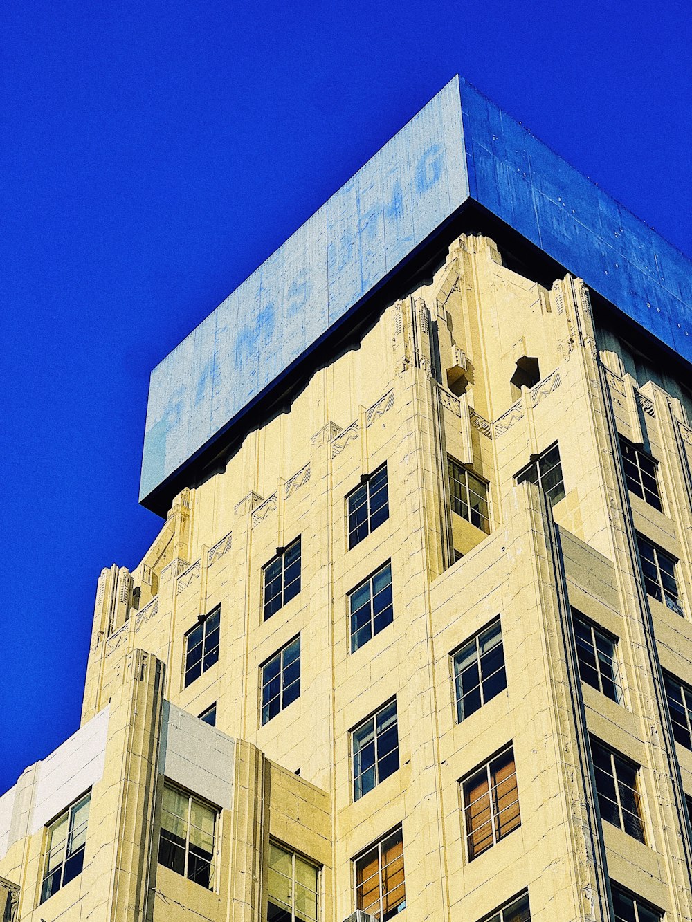 a tall building with a blue sky in the background