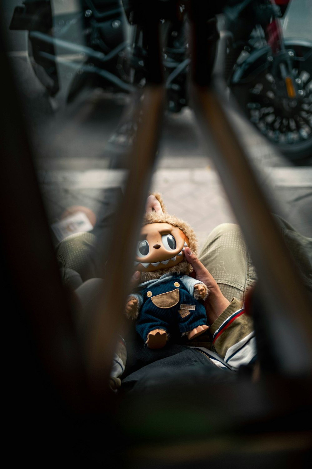 a stuffed animal is sitting on a person's lap