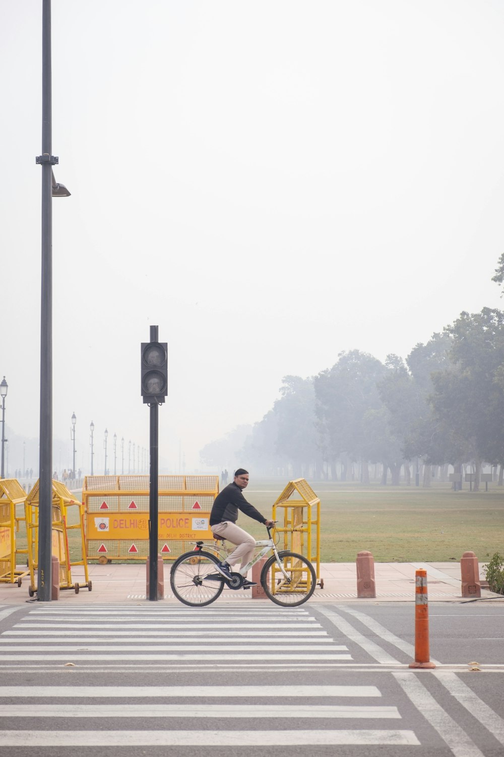 a man riding a bike across a cross walk