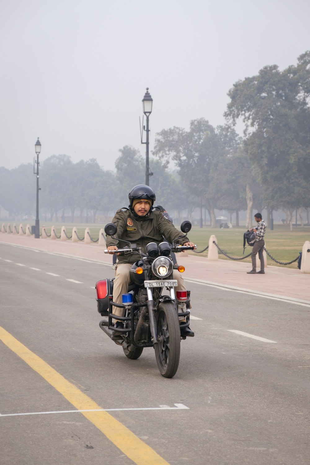 a man riding a motorcycle down a street