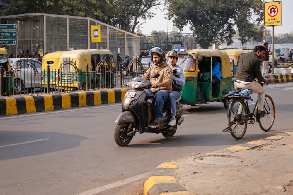 two men riding on the back of a motorcycle down a street