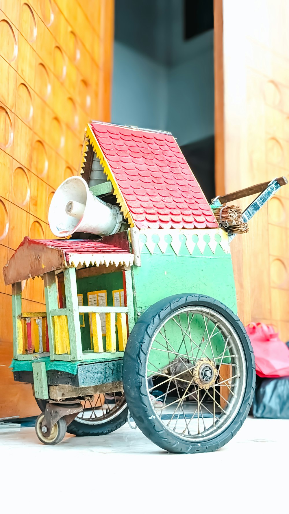 uma casa de brinquedo sobre rodas no chão