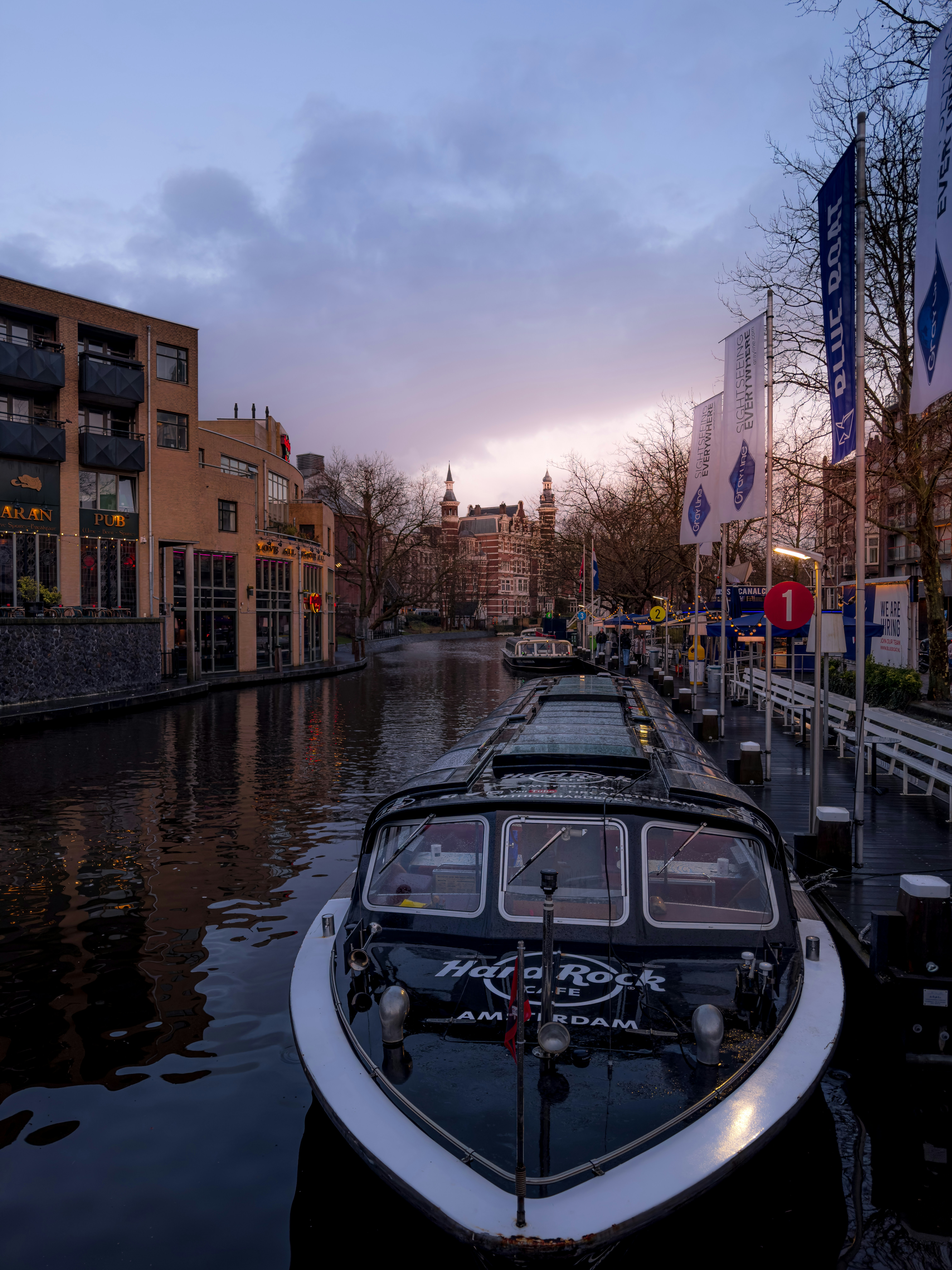a row of boats sitting next to each other on a river