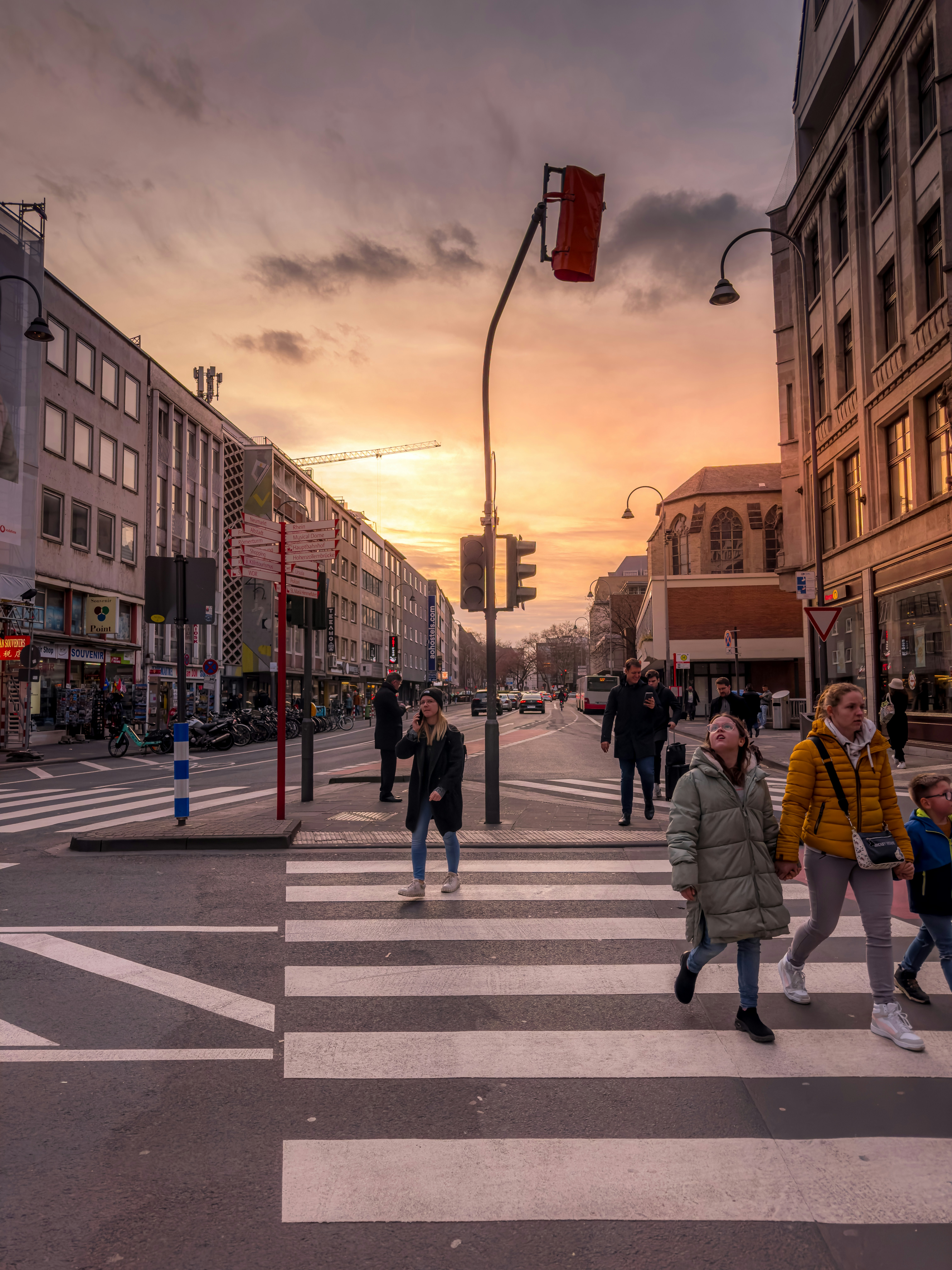a group of people walking across a cross walk