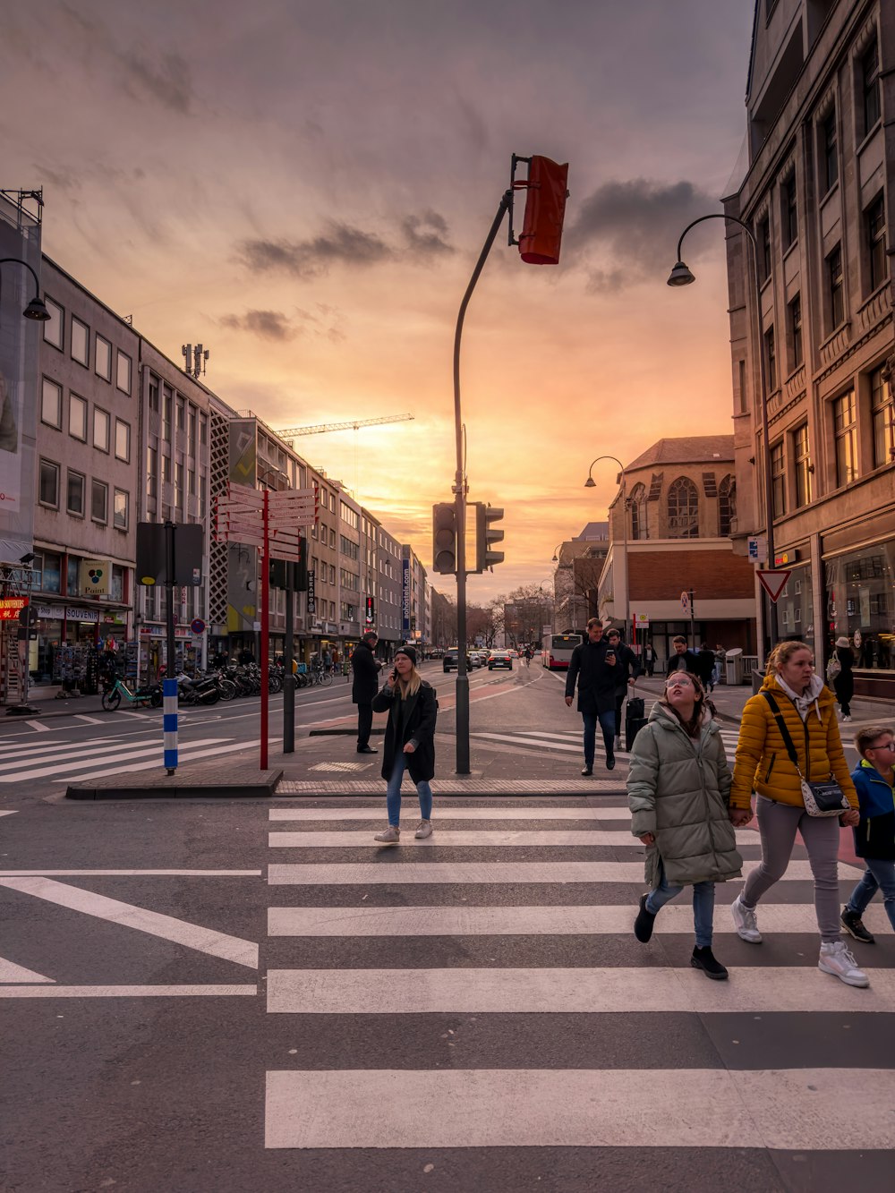 a group of people walking across a cross walk