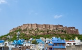 a very tall hill with a very tall building on top of it