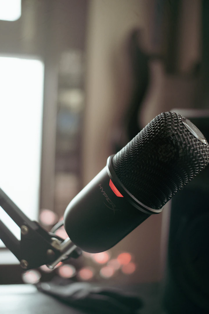 A small portable cardioid microphone resting on a tabletop — the kind of compact rig you take up a hillside to record outdoors