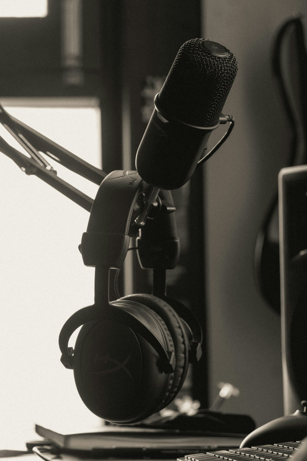 a black and white photo of a microphone and headphones