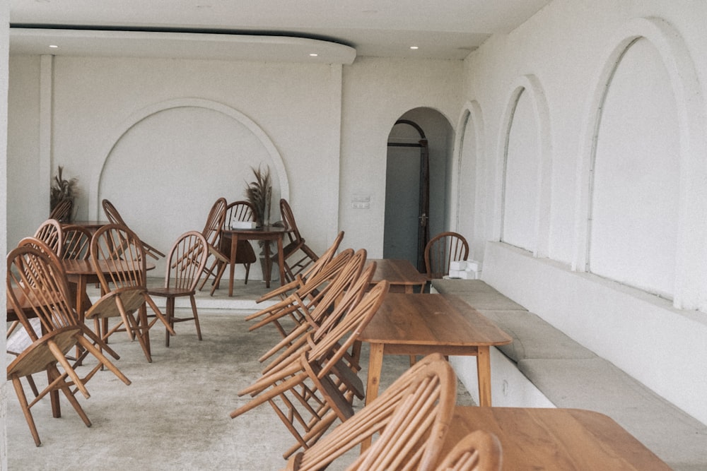 a room filled with lots of wooden tables and chairs