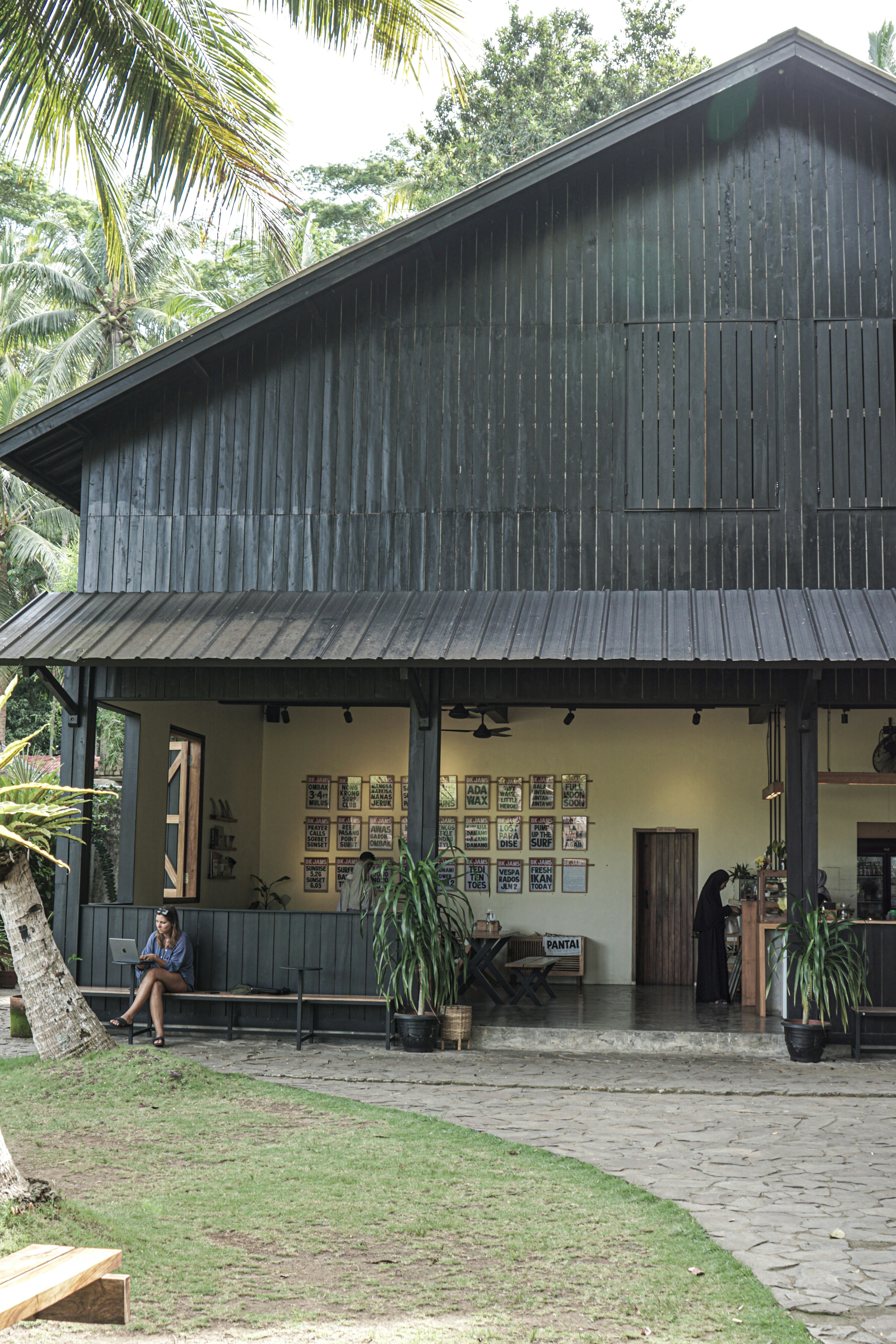 a person sitting on a bench in front of a building