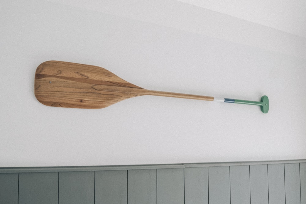 a wooden paddle mounted to a wall